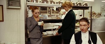 Movie still from “Last Holiday” (2006), directed by Wayne Wang – Two women in a kitchen eating some food; Medium shot, Over the shoulder angle