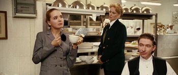 Movie still from “Last Holiday” (2006), directed by Wayne Wang – A woman holding a bowl in her hand while another woman stands next to her; Medium shot, Over the shoulder angle