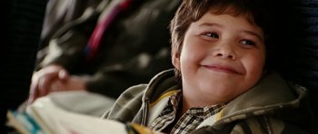 Movie still from “Last Holiday” (2006), directed by Wayne Wang – A child smiling at the camera; Close Up shot, Over the shoulder angle