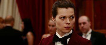 Movie still from “Last Holiday” (2006), directed by Wayne Wang – A person wearing a suit and bow tie; Close Up shot, Over the shoulder angle