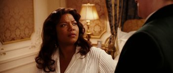 Movie still from “Last Holiday” (2006), directed by Wayne Wang – A woman sitting in front of a lamp; Close Up shot, Over the shoulder angle