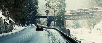 Movie still from “Last Holiday” (2006), directed by Wayne Wang – A car driving down a road in the snow; Extreme Wide shot, Low angle