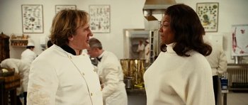Movie still from “Last Holiday” (2006), directed by Wayne Wang – Two people in white uniforms talking in a kitchen; Medium shot, Over the shoulder angle