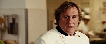 Movie still from “Last Holiday” (2006), directed by Wayne Wang – A person wearing a chef's outfit; Close Up shot, Low angle