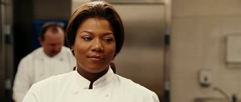 Movie still from “Last Holiday” (2006), directed by Wayne Wang – A person wearing a chef's outfit; Close Up shot, Over the shoulder angle