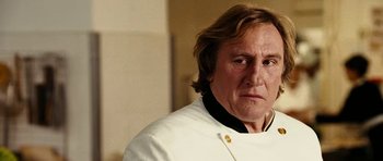 Movie still from “Last Holiday” (2006), directed by Wayne Wang – A person wearing a chef's outfit; Close Up shot, Low angle