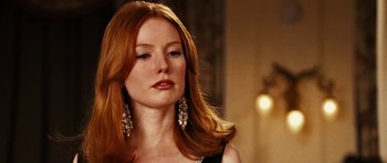 Movie still from “Last Holiday” (2006), directed by Wayne Wang – A woman with long red hair wearing a black dress; Close Up shot, Over the shoulder angle