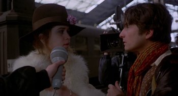 Movie still from “Last Tango in Paris” (1972), directed by Bernardo Bertolucci – A woman wearing a hat is being interviewed by a man; Close Up shot, Over the shoulder angle
