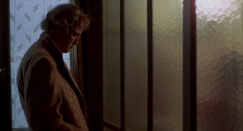Movie still from “Last Tango in Paris” (1972), directed by Bernardo Bertolucci – A man standing in front of a window; Close Up shot, Over the shoulder angle
