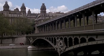 Movie still from “Last Tango in Paris” (1972), directed by Bernardo Bertolucci – A bridge over a body of water near a building; Extreme Wide shot, High angle