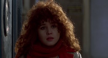 Movie still from “Last Tango in Paris” (1972), directed by Bernardo Bertolucci – A young woman with a red scarf is looking at the camera; Close Up shot, Over the shoulder angle