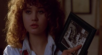 Movie still from “Last Tango in Paris” (1972), directed by Bernardo Bertolucci – A woman holding an old picture of herself; Close Up shot, Over the shoulder angle