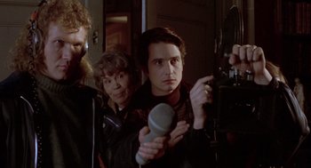 Movie still from “Last Tango in Paris” (1972), directed by Bernardo Bertolucci – A group of people standing next to each other in a room; Close Up shot, Low angle