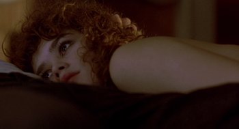 Movie still from “Last Tango in Paris” (1972), directed by Bernardo Bertolucci – A person laying on a bed; Close Up shot, Overhead angle
