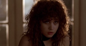 Movie still from “Last Tango in Paris” (1972), directed by Bernardo Bertolucci – A person with curly brown hair; Close Up shot, Over the shoulder angle