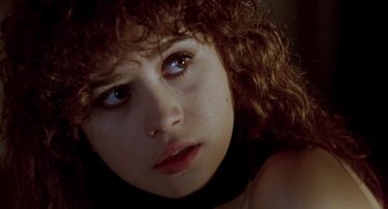 Movie still from “Last Tango in Paris” (1972), directed by Bernardo Bertolucci – A person with curly hair; Close Up shot, High angle