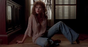 Movie still from “Last Tango in Paris” (1972), directed by Bernardo Bertolucci – A woman sitting on the ground in a room; Medium shot, Low angle