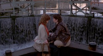 Movie still from “Last Tango in Paris” (1972), directed by Bernardo Bertolucci – Two women sitting on a bench near a waterfall; Wide shot, High angle