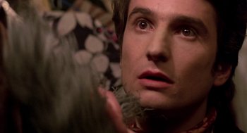 Movie still from “Last Tango in Paris” (1972), directed by Bernardo Bertolucci – A man's face with feathers in his hair; Close Up shot, Over the shoulder angle