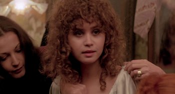 Movie still from “Last Tango in Paris” (1972), directed by Bernardo Bertolucci – A young woman with long , curly hair is brushing her hair; Close Up shot, Over the shoulder angle