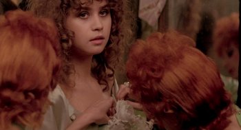 Movie still from “Last Tango in Paris” (1972), directed by Bernardo Bertolucci – A young woman with red hair looking into a mirror; Close Up shot, Over the shoulder angle