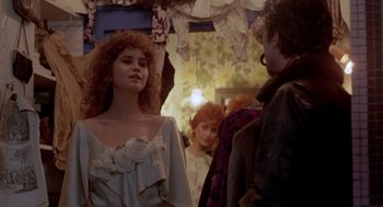 Movie still from “Last Tango in Paris” (1972), directed by Bernardo Bertolucci – A group of people standing next to each other in a room; Medium shot, Over the shoulder angle