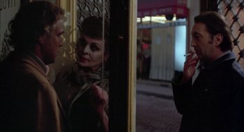 Movie still from “Last Tango in Paris” (1972), directed by Bernardo Bertolucci – A man and a woman standing next to each other in front of a building; Close Up shot, Over the shoulder angle
