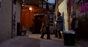 Movie still from “Last Tango in Paris” (1972), directed by Bernardo Bertolucci – A man and a woman walking down a street; Wide shot, Over the shoulder angle