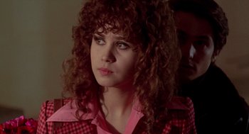 Movie still from “Last Tango in Paris” (1972), directed by Bernardo Bertolucci – A person with curly hair wearing a pink shirt; Close Up shot, Over the shoulder angle