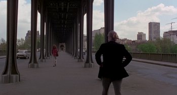 Movie still from “Last Tango in Paris” (1972), directed by Bernardo Bertolucci – A woman and a child are walking on a bridge; Wide shot, Over the shoulder angle
