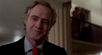 Movie still from “Last Tango in Paris” (1972), directed by Bernardo Bertolucci – A person wearing a suit and tie; Close Up shot, Low angle