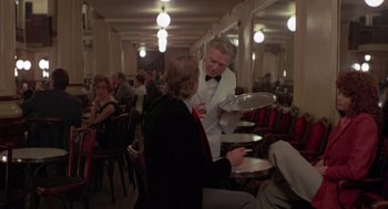 Movie still from “Last Tango in Paris” (1972), directed by Bernardo Bertolucci – A man serving a woman at a restaurant; Wide shot, Over the shoulder angle
