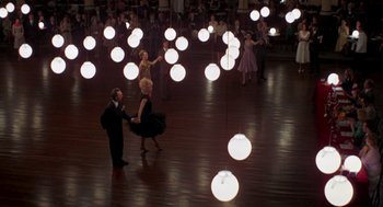 Movie still from “Last Tango in Paris” (1972), directed by Bernardo Bertolucci – A group of people dancing in a room with lights; Extreme Wide shot, High angle