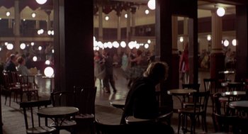 Movie still from “Last Tango in Paris” (1972), directed by Bernardo Bertolucci – A group of people dancing in a room; Wide shot, Over the shoulder angle