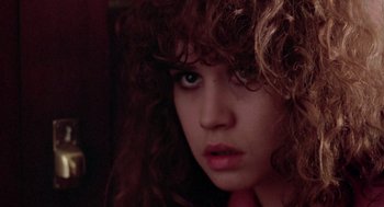 Movie still from “Last Tango in Paris” (1972), directed by Bernardo Bertolucci – A person with curly brown hair; Close Up shot, Over the shoulder angle