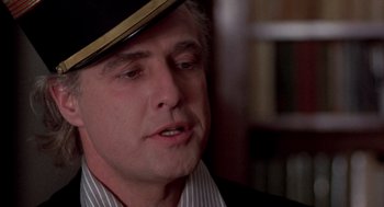 Movie still from “Last Tango in Paris” (1972), directed by Bernardo Bertolucci – A person wearing a hat; Close Up shot, Low angle