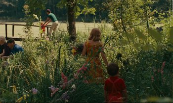 Movie still from “Happiness” (1965), directed by Agnès Varda – A woman and a child in a field of flowers; Extreme Wide shot, High angle