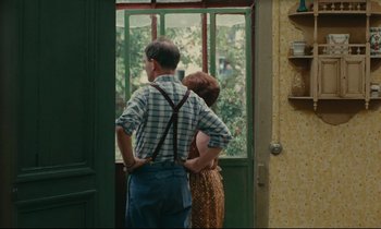 Movie still from “Happiness” (1965), directed by Agnès Varda – A man and a woman looking out of a window; Medium shot, Over the shoulder angle
