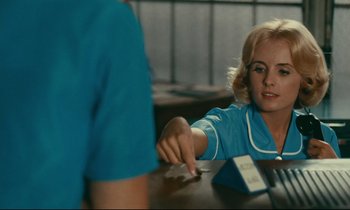 Movie still from “Happiness” (1965), directed by Agnès Varda – A woman sitting at a table in front of a man; Close Up shot, Over the shoulder angle