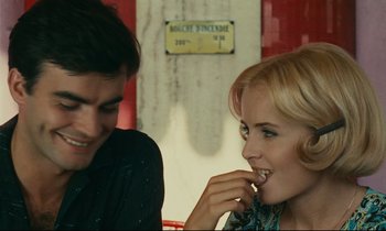 Movie still from “Happiness” (1965), directed by Agnès Varda – A man and a woman sitting next to each other at a table; Close Up shot, Over the shoulder angle