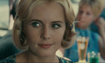 Movie still from “Happiness” (1965), directed by Agnès Varda – A person wearing a necklace; Close Up shot, Over the shoulder angle