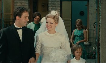 Movie still from “Happiness” (1965), directed by Agnès Varda – A woman in a wedding dress and a veil; Medium shot, Low angle