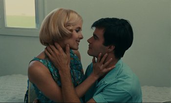 Movie still from “Happiness” (1965), directed by Agnès Varda – A man and a woman are looking at one another; Close Up shot, High angle