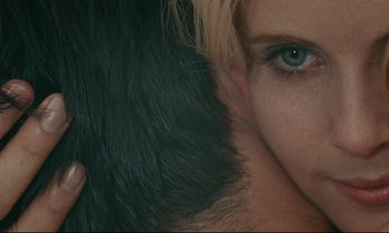 Movie still from “Happiness” (1965), directed by Agnès Varda – A woman's face and a man's hair; Extreme Close Up shot, Overhead angle