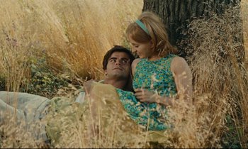 Movie still from “Happiness” (1965), directed by Agnès Varda – A man and a woman laying in a field; Medium shot, High angle