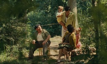 Movie still from “Happiness” (1965), directed by Agnès Varda – A group of people sitting in the grass; Wide shot, High angle