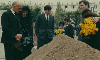 Movie still from “Happiness” (1965), directed by Agnès Varda – A group of people standing around a pile of dirt; Wide shot, Low angle