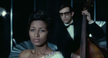 Movie still from “Le Samouraï” (1967), directed by Jean-Pierre Melville – A man and a woman in formal attire; Medium shot, Low angle