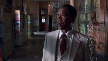 Movie still from “Lean on Me” (1989), directed by John G. Avildsen – A man in a white suit and a red tie; Close Up shot, Low angle