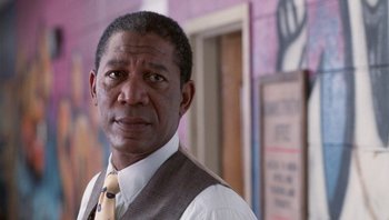 Movie still from “Lean on Me” (1989), directed by John G. Avildsen – A person wearing a suit and a tie; Close Up shot, Low angle